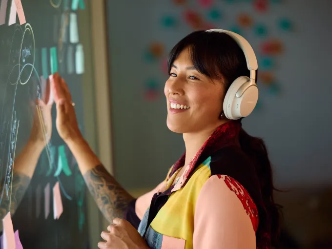 Woman wearing Bose QuietComfort Ultra Headphones.  