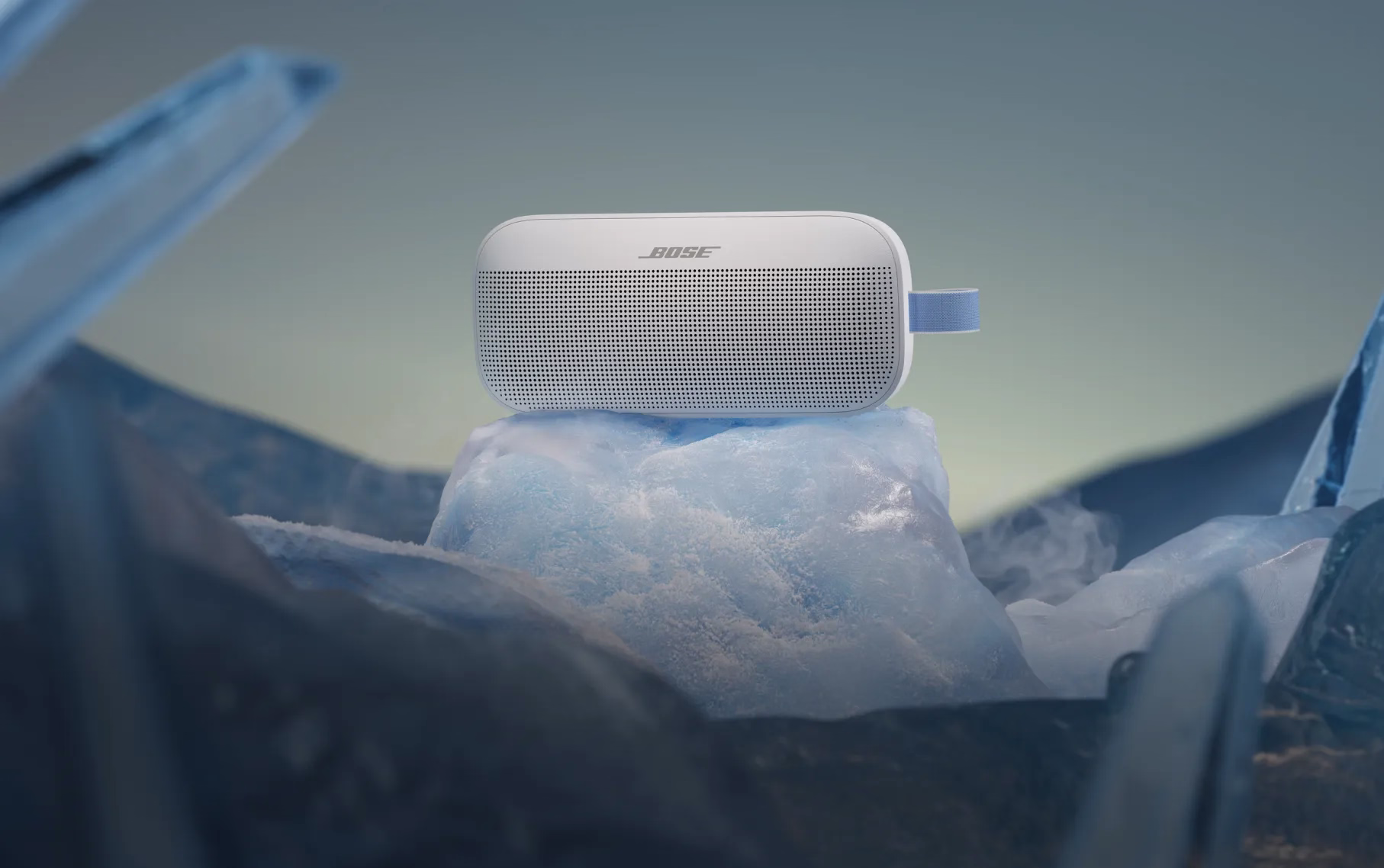 Bose SoundLink Flex Portable Speaker (2nd Gen) in Fog Gray surround by glacial ice.